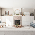 Bright neutral living room with fireplace, white built-ins, and styled mantel